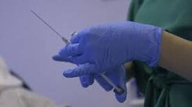 syringe in the hands of a doctor